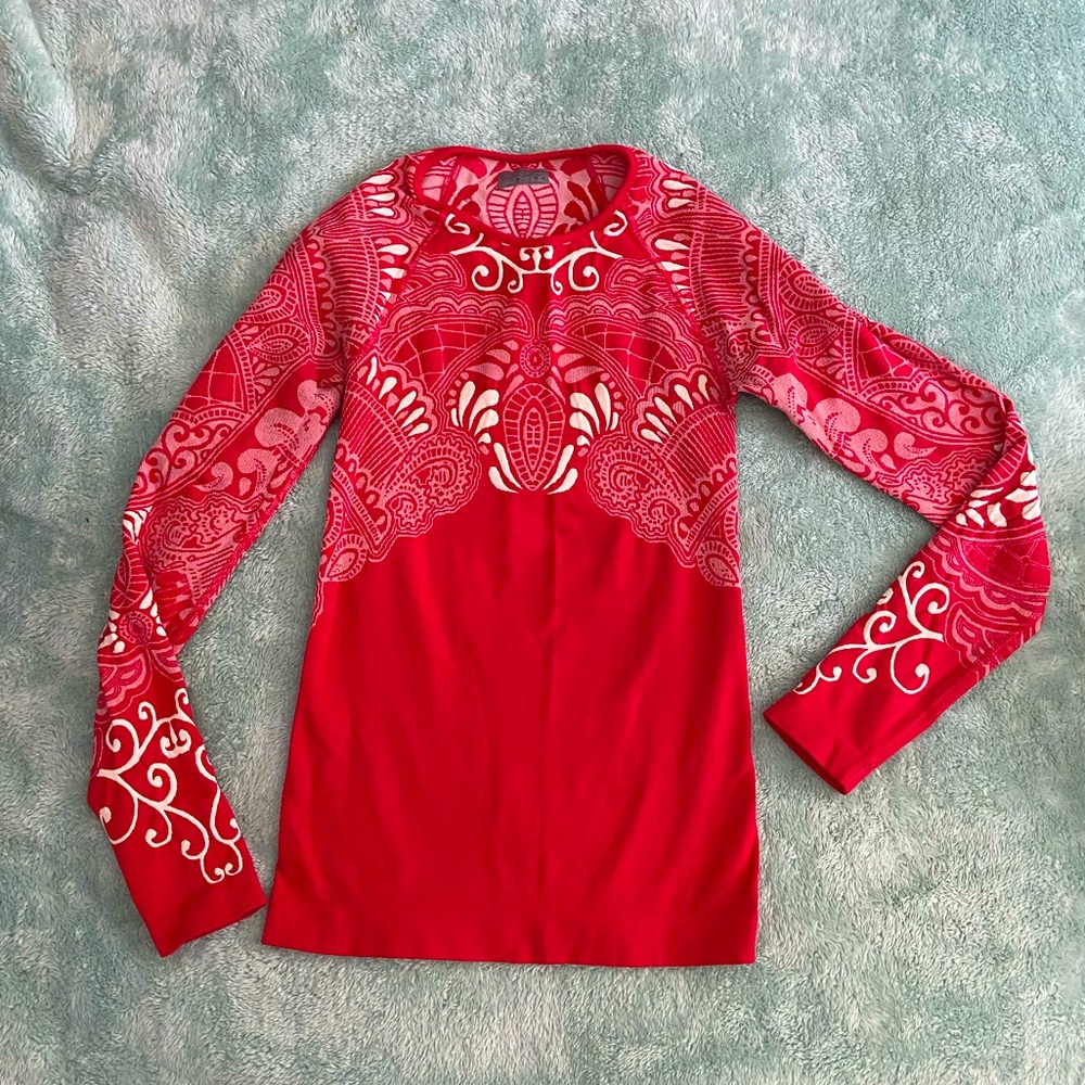 Athleta women’s small red base layer.  Flattering design.
